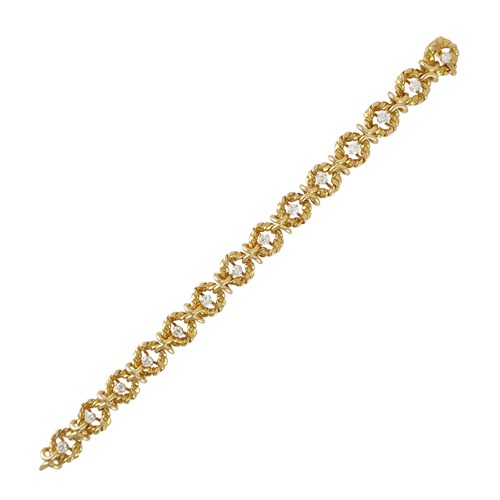 Yellow gold and diamond bracelet by Van Cleef & Arpels, Paris, with gold wirework entwined circles each centred by a diamond,